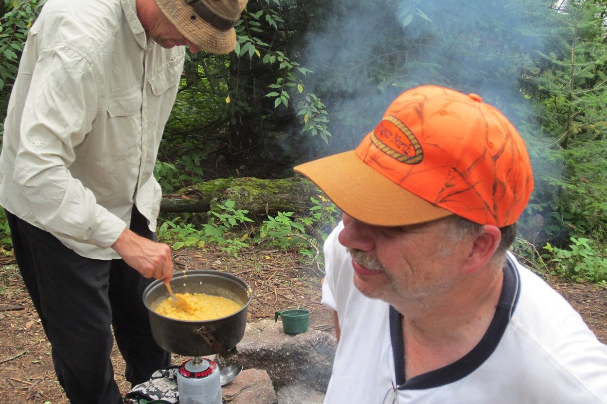 A camp stove boiling water on a cold morning