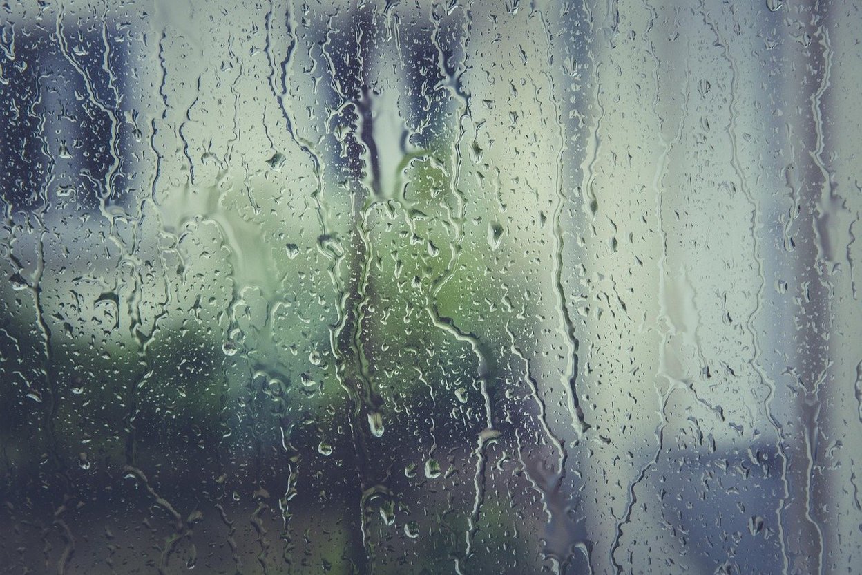 Water droplets on the inside of a camper window on a cold morning