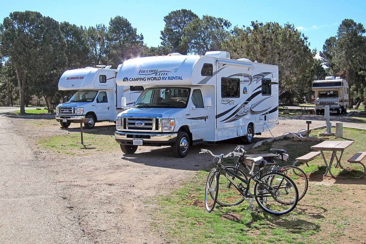 An RV power pedestal with plugs at a campground site