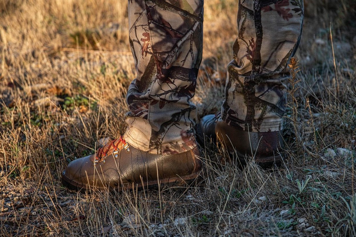A hunter in camouflage walking outdoors