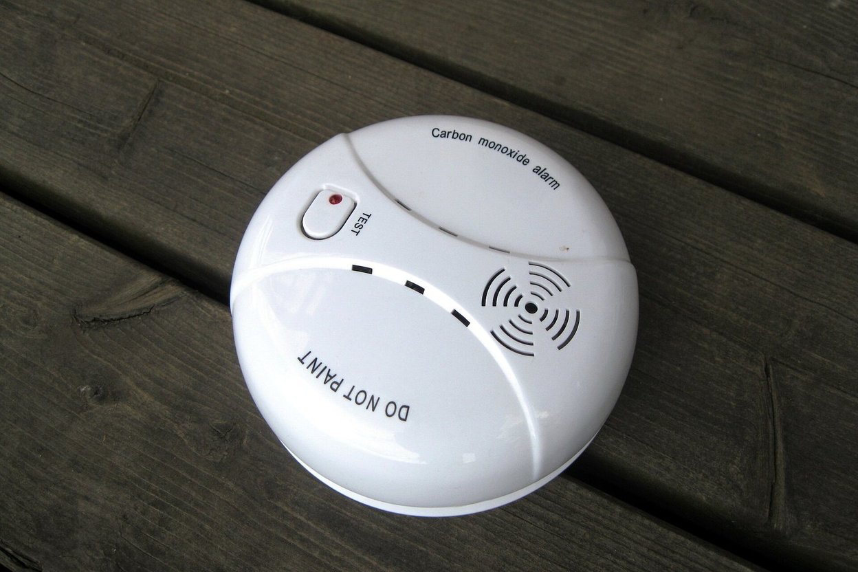 A carbon monoxide alarm mounted on a camper wall
