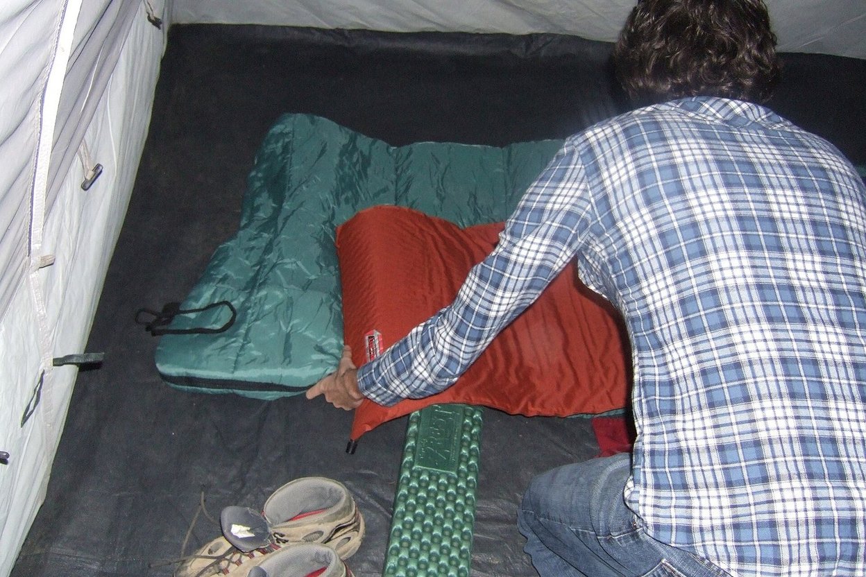 A sleeping pad and sleeping bag inside a tent